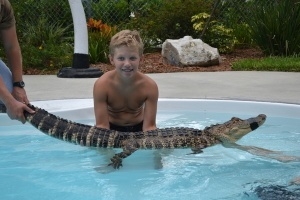 Swimming with Gators - Boy holding gator